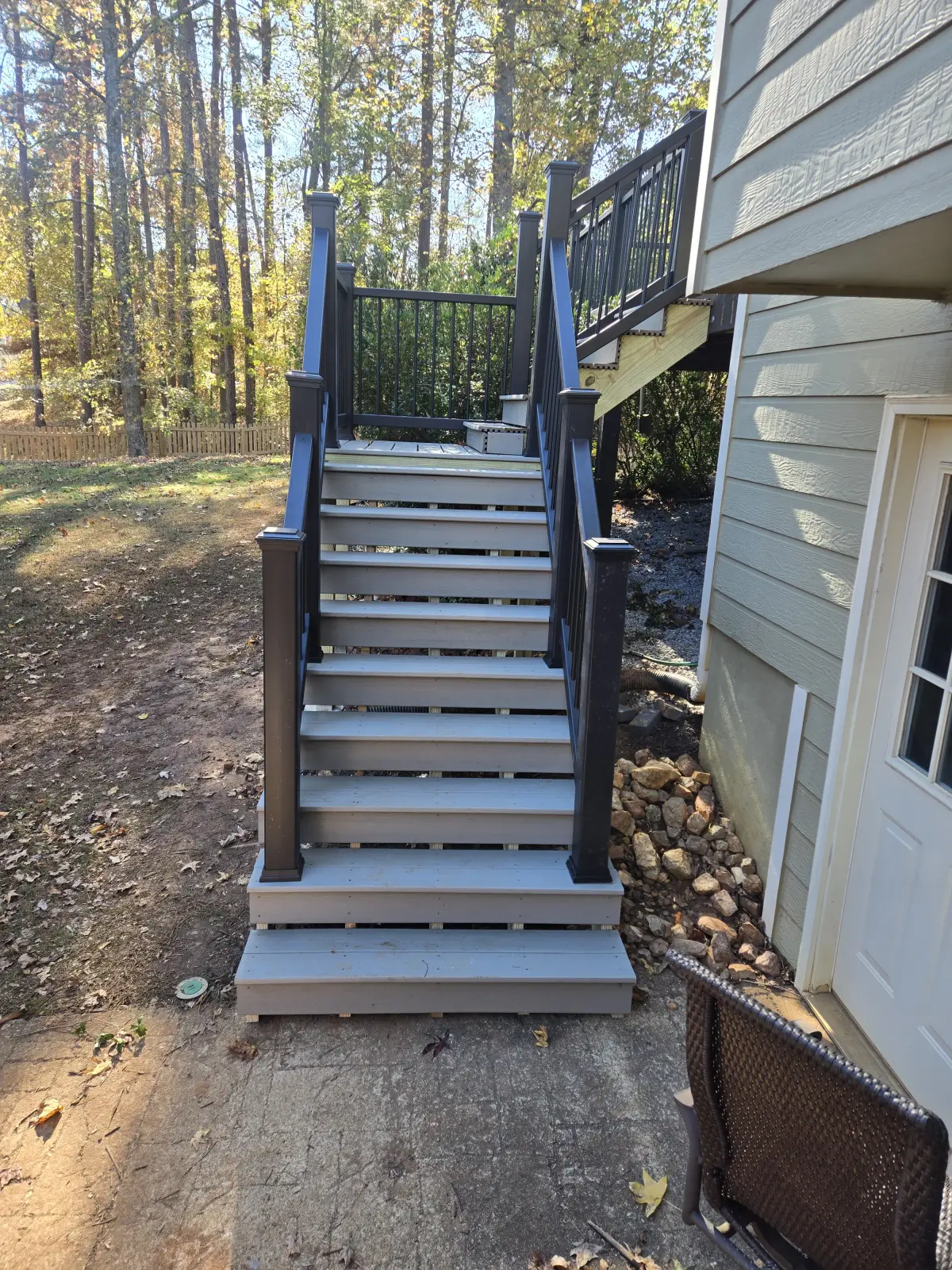 Composite deck stairs with black railings from ground level