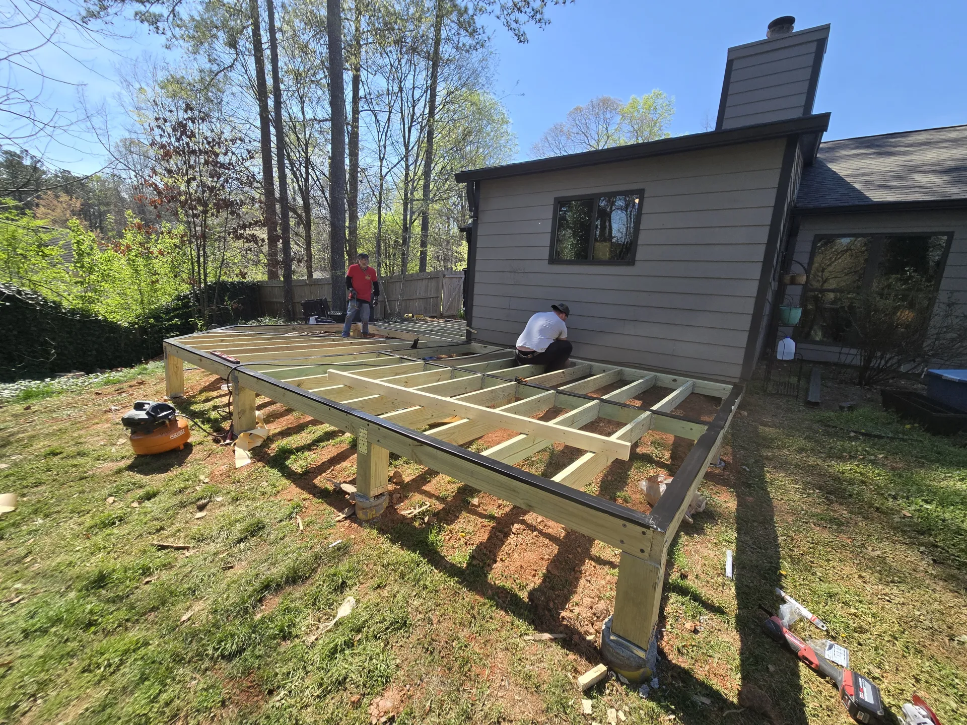 Workers installing deck joists