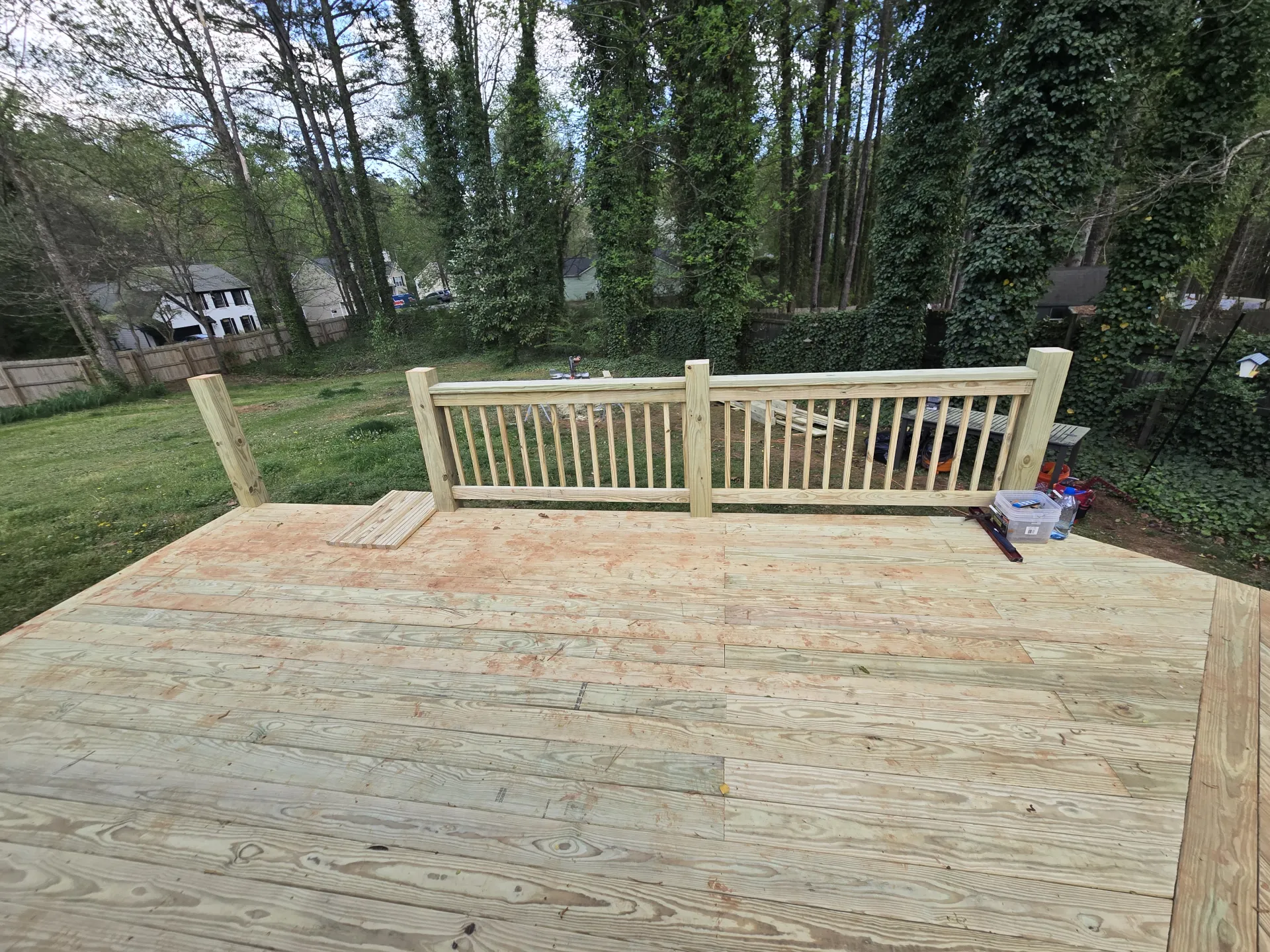 Deck with wood railing being installed