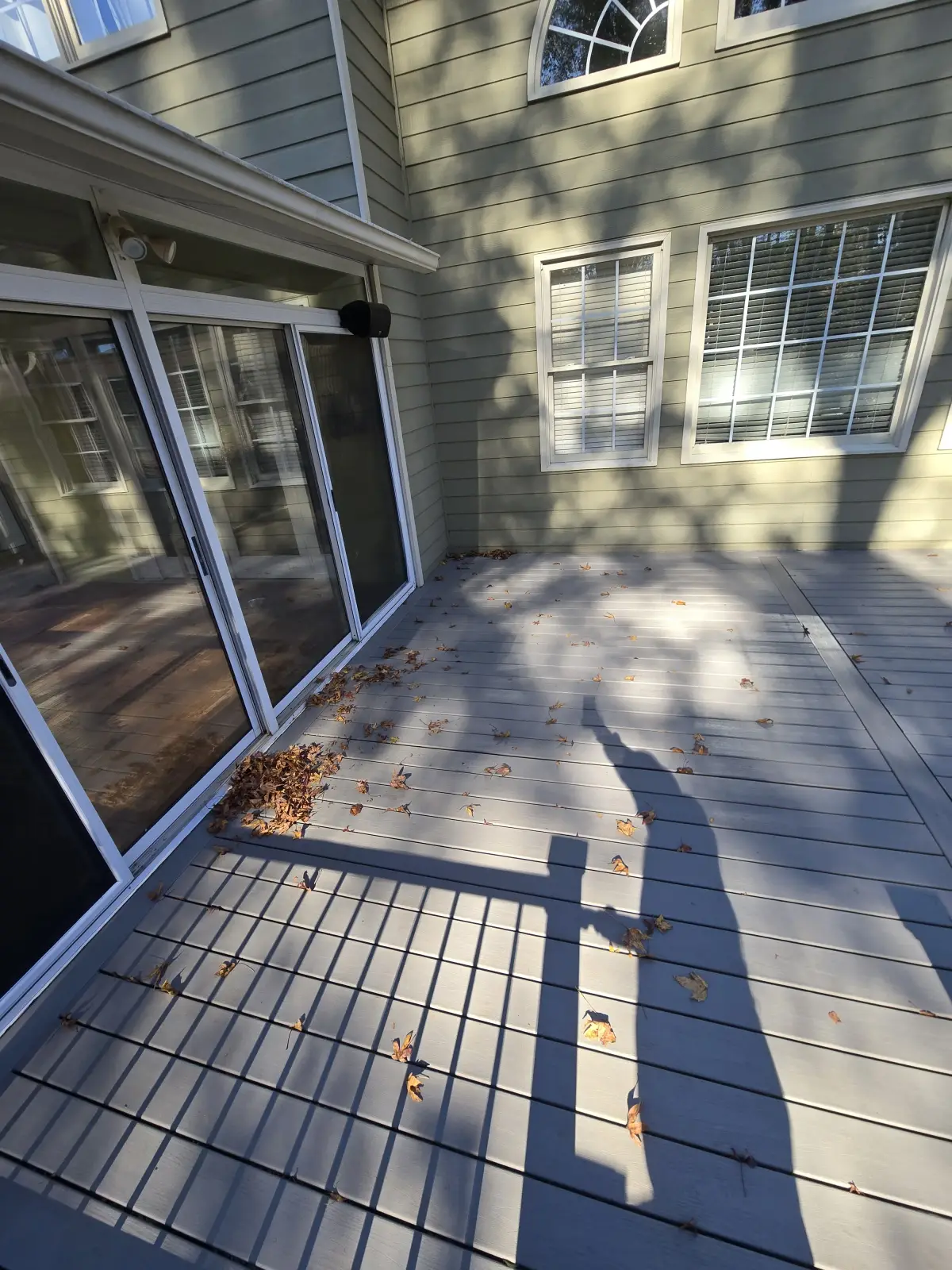Deck facing house with sliding doors and screened porch