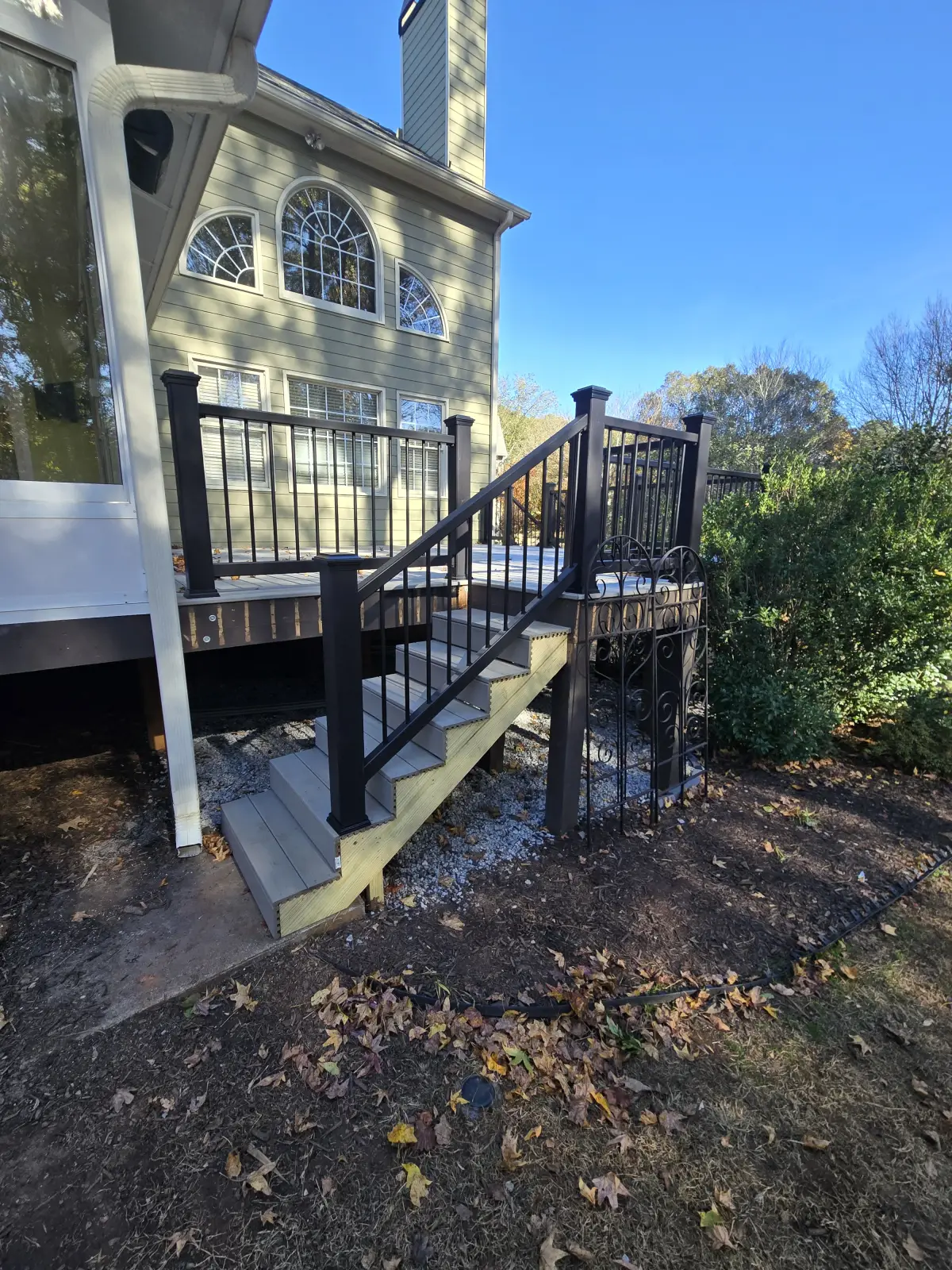 Full deck staircase with decorative iron gate