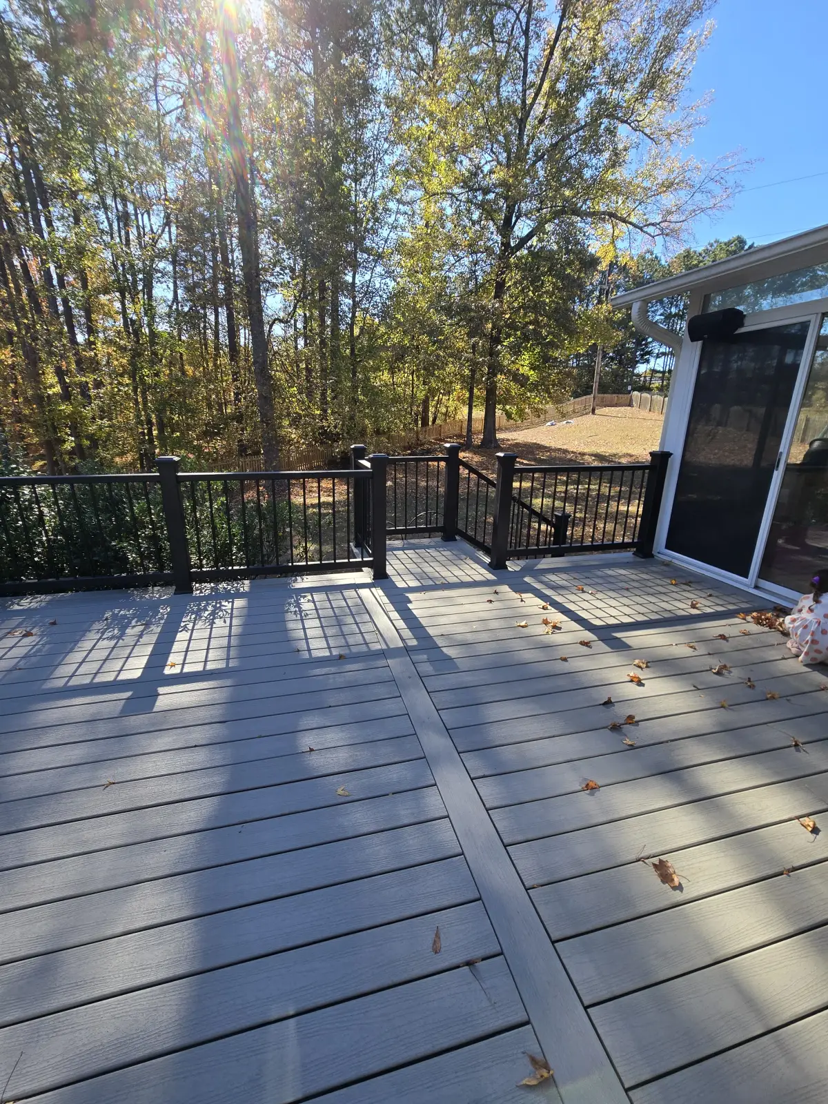 Wide composite deck with sun flare and black railings in Acworth Georgia