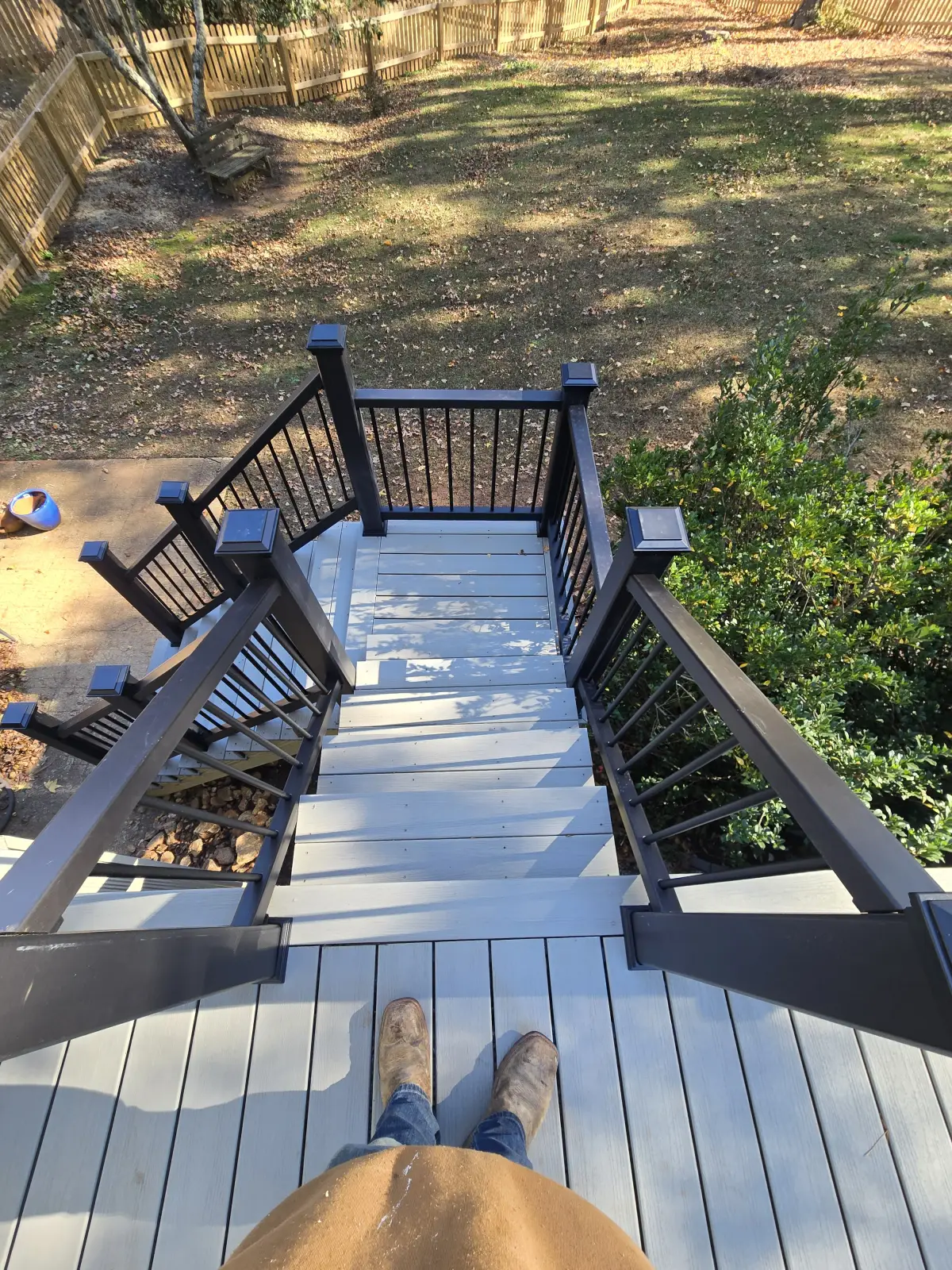 L-shaped deck stairs custom design leading to backyard