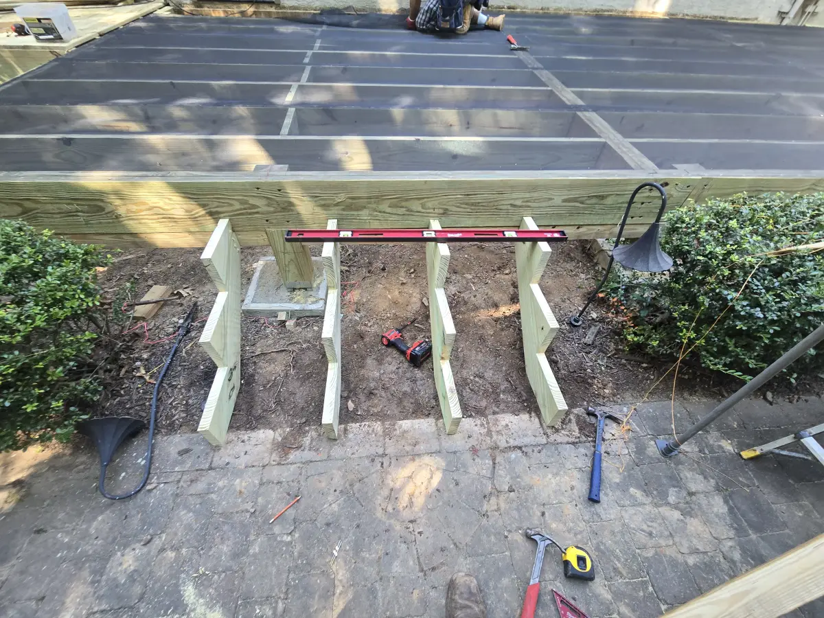 Deck stair stringers being installed during construction